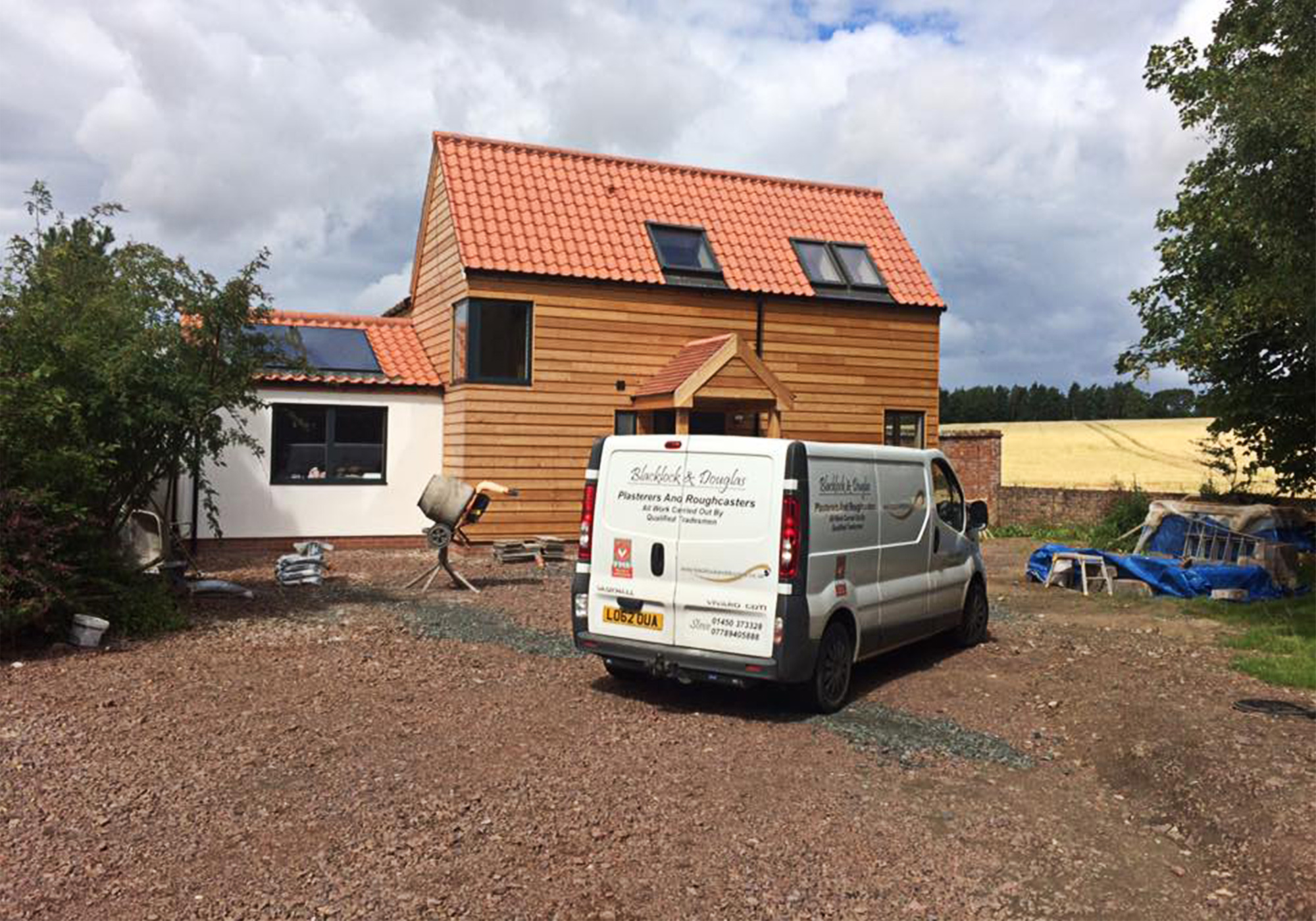 An image of our van sitting outside a house we plastered