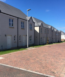 An image of the front of a set of houses we plastered