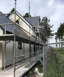 An image of a house we worked on surrounded by scaffolding